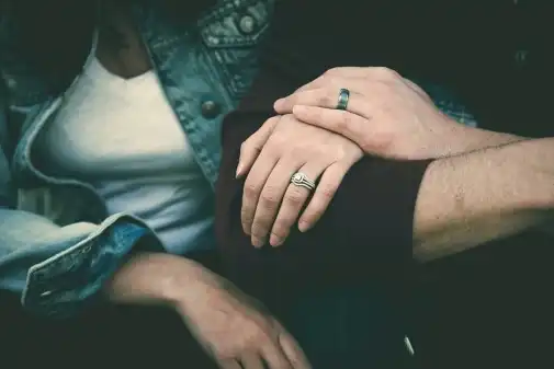 A couple with linked arms and holding hands